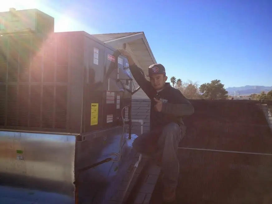 HVAC technician performing Air Duct Repair on a rooftop unit in Hawthorn Woods